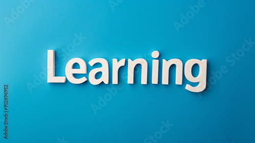 White lettering spells out the word learning against a bright blue backdrop © Michael
