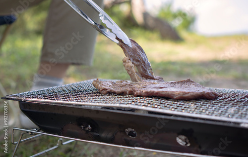 Grilling meat outdoors. have a  barbeque. BBQ, camp, camp site, grill, outdoor, etc.  外で肉を焼く。バーべーキュー、キャンプ、キャンプ場、グリル、アウトドアなど photo