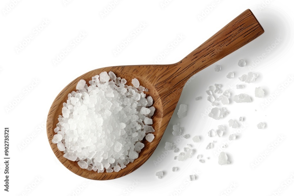 A wooden spoon filled with sea salt on a white surface, ideal for cooking or as a decorative item A wooden spoon filled with sea salt on a white surface, ideal for cooking or as a decorative item