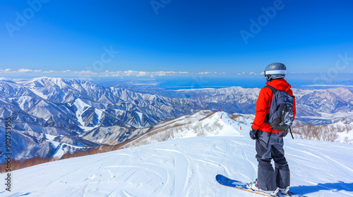 Man with snowboard standing on snowy mountain