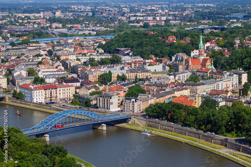 Pilsudski Bridge leading from Old town of Krakow through Vistula river to Podgorze district with St. Joseph's Church towering over it. View from observation viewing platform on tethered balloon 