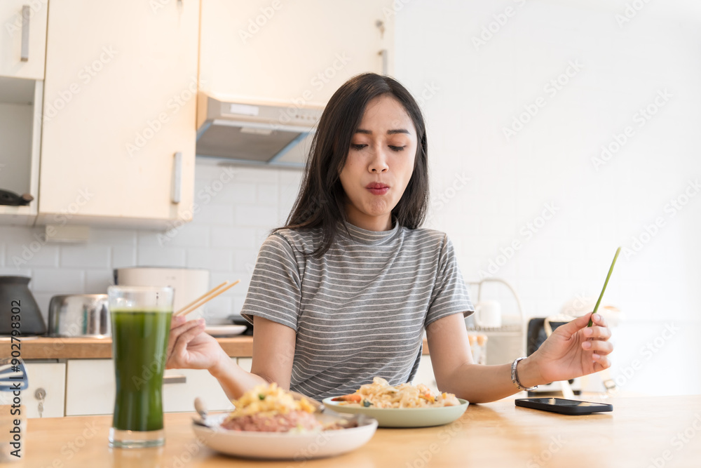 Asian Girl eating Thai food in kitchen counter Home delivery food feeling happy Asian Girl eating Thai food in kitchen counter Home delivery food feeling happy