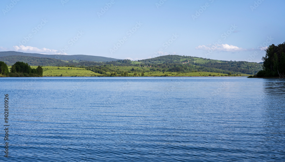 Vlasina lake scenery with beautiful clouds in the blue sky. Beautiful semi-artificial lake in Southeast Serbia. The beautiful blue color of the water. Vlasina lake scenery with beautiful clouds in the blue sky. Beautiful semi-artificial lake in Southeast Serbia. The beautiful blue color of the water.