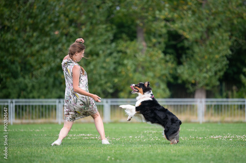 Girl is playing with her happy dog.  photo