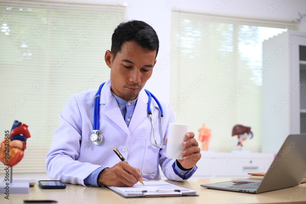 A male gynecologist examines prosthetic organs in a medical room, ensuring their quality and accuracy for training and patient care purposes. A male gynecologist examines prosthetic organs in a medical room, ensuring their quality and accuracy for training and patient care purposes.