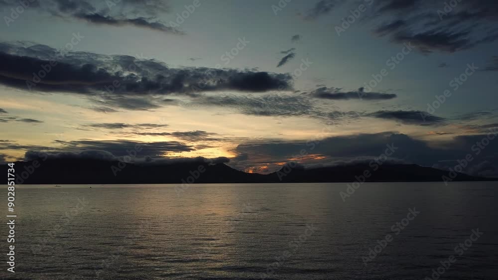 dawn over the sea against the backdrop of tropical mountains and clouds dawn over the sea against the backdrop of tropical mountains and clouds