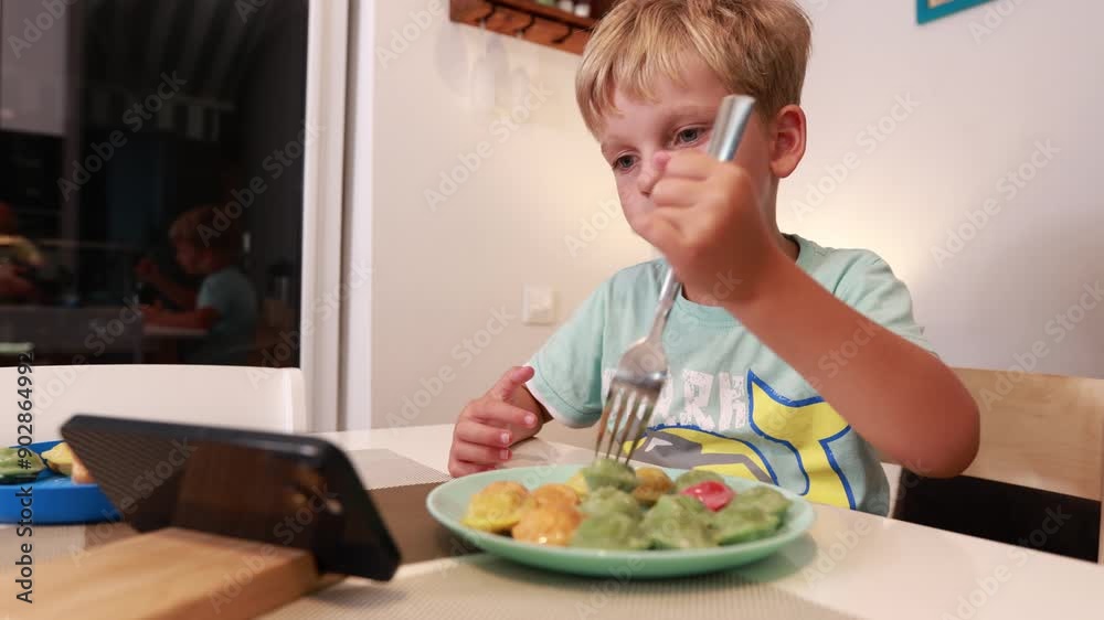 Caucasian Boy Enjoys Delicious Meal in Kitchen While Sitting at Table Caucasian Boy Enjoys Delicious Meal in Kitchen While Sitting at Table