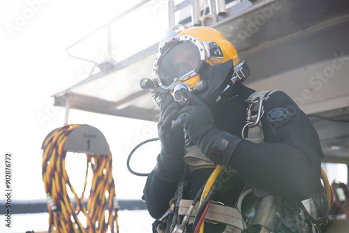 Commercial diver entering water in protective helmet