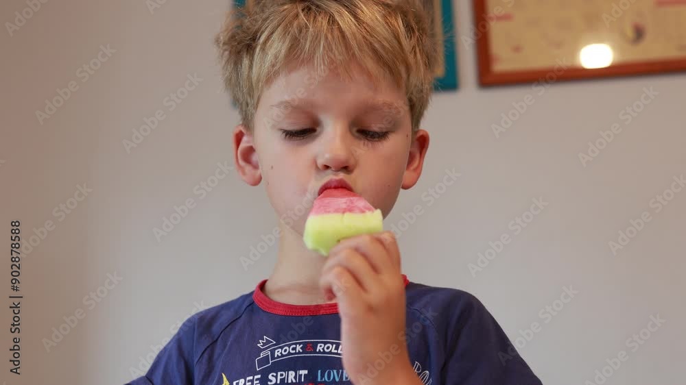 Caucasian Boy Enjoys Ice Cream Treat in Kitchen During Afternoon Snack Time Caucasian Boy Enjoys Ice Cream Treat in Kitchen During Afternoon Snack Time