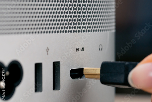 Close-up of USB ports in a computer with a metal case, many different connectors, inserted Type- wires connector designators female hand inserts HDMI photo