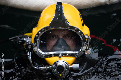 Commercial diver in Kirby Morgan helmet on water surface