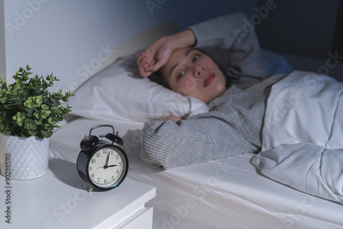 Fotografia Annoyed, stressed, anxiety asian young woman suffering from insomnia, frustrated awake on bed at night, headache or migraine, health care problem, disturbed trouble of loud noise, unable sleepless