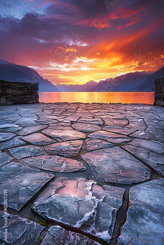 Stonetiled floor extending towards a stunning mountain landscape at sunset, wideangle shot, vibrant colors, serene and expansive photo