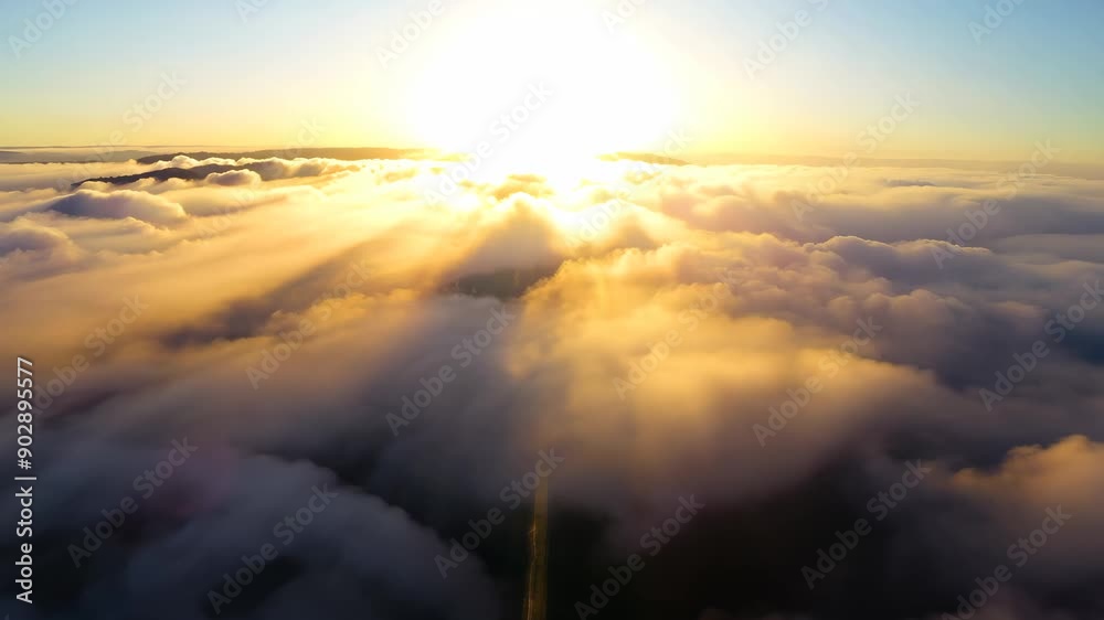 Sunrise above clouds with golden light, aerial Sunrise above clouds with golden light, aerial