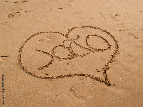 Heart drawn in beach sand with the name João inside, capturing a romantic and personal touch.