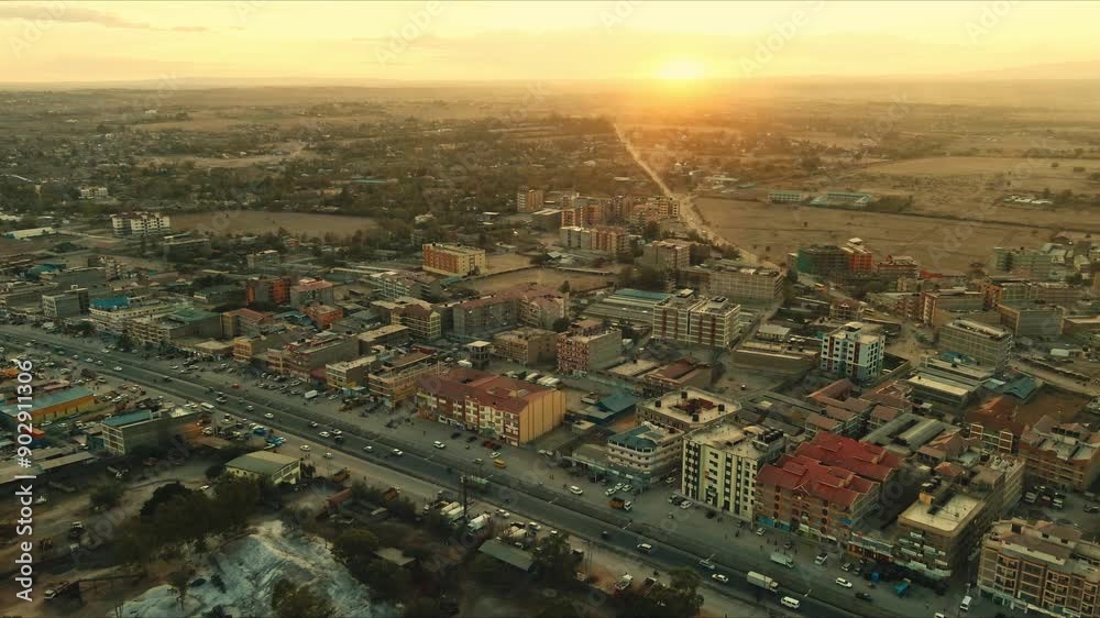 Warm sunlight bathes a bustling cityscape at sunset, casting long shadows on the urban sprawl in this captivating aerial view. Warm sunlight bathes a bustling cityscape at sunset, casting long shadows on the urban sprawl in this captivating aerial view.