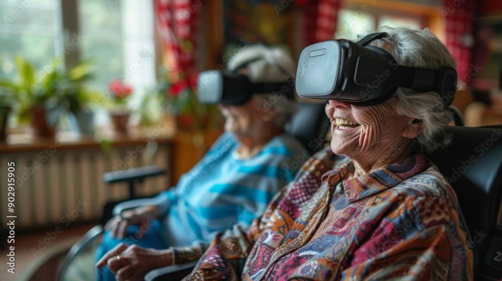 Obraz premium Elderly women watching video through virtual reality glasses enjoying modern technology, nursing home