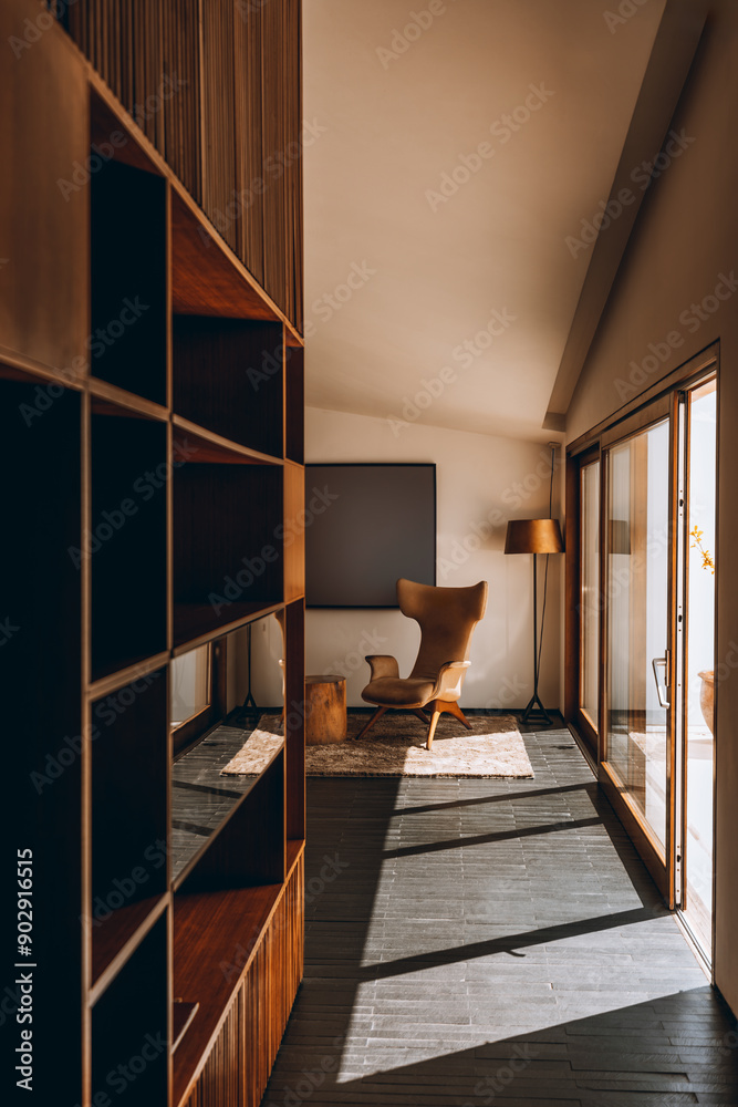 custom made wallpaper toronto digitalA modern, sunlit interior features a cozy reading nook with a stylish armchair, a wooden floor lamp, a soft rug, and large windows. Minimalist decor with warm tones