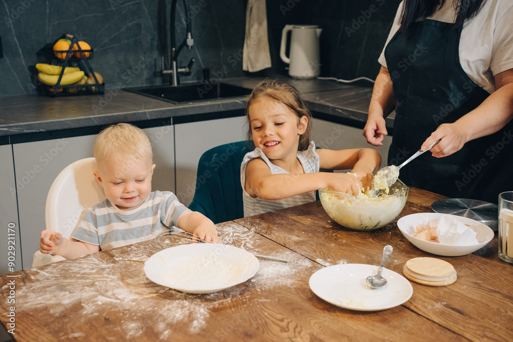 Children Engaging in Fun Baking Activities Together in a Warm and Cozy Kitchen Space. Happy family enjoys moments of cooking at home. Children Engaging in Fun Baking Activities Together in a Warm and Cozy Kitchen Space. Happy family enjoys moments of cooking at home.