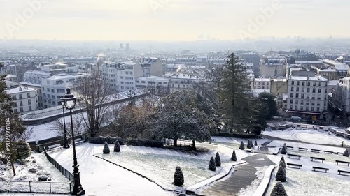 Panoramic cityscape of Paris under snow.