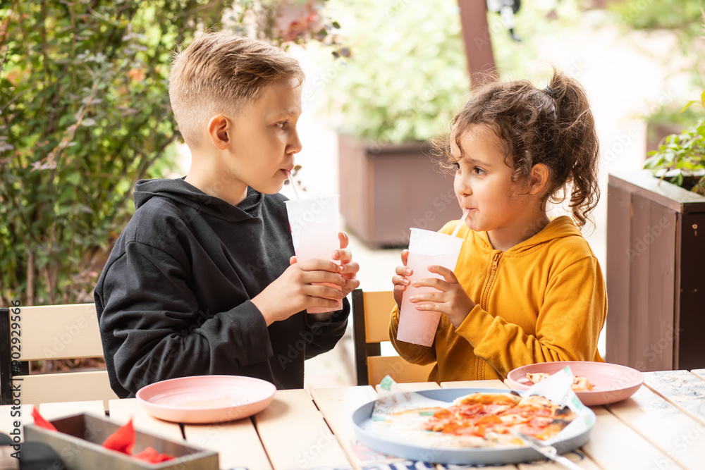 Cute girl and teenager boy eat pizza lunch in outdoor cafe and having fun. Cute girl and teenager boy eat pizza lunch in outdoor cafe and having fun.