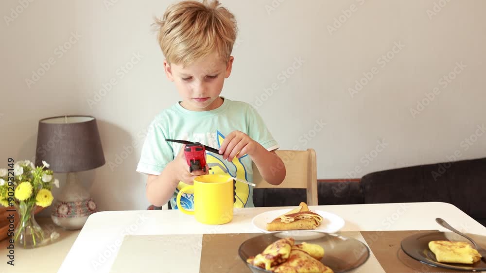 Young Boy Enjoys Breakfast in Cozy Kitchen Setting With Delicious Food Young Boy Enjoys Breakfast in Cozy Kitchen Setting With Delicious Food