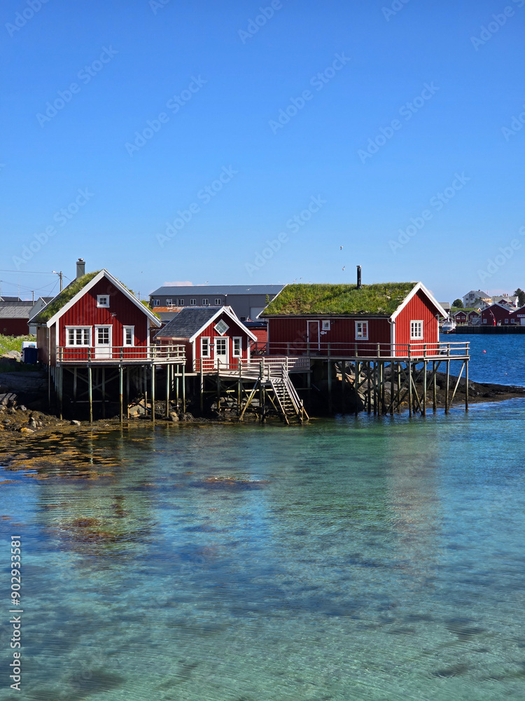 Charming Red Cabins On Stilts Over Crystal Clear Waters In Norway, Lofoten Norway Charming Red Cabins On Stilts Over Crystal Clear Waters In Norway, Lofoten Norway