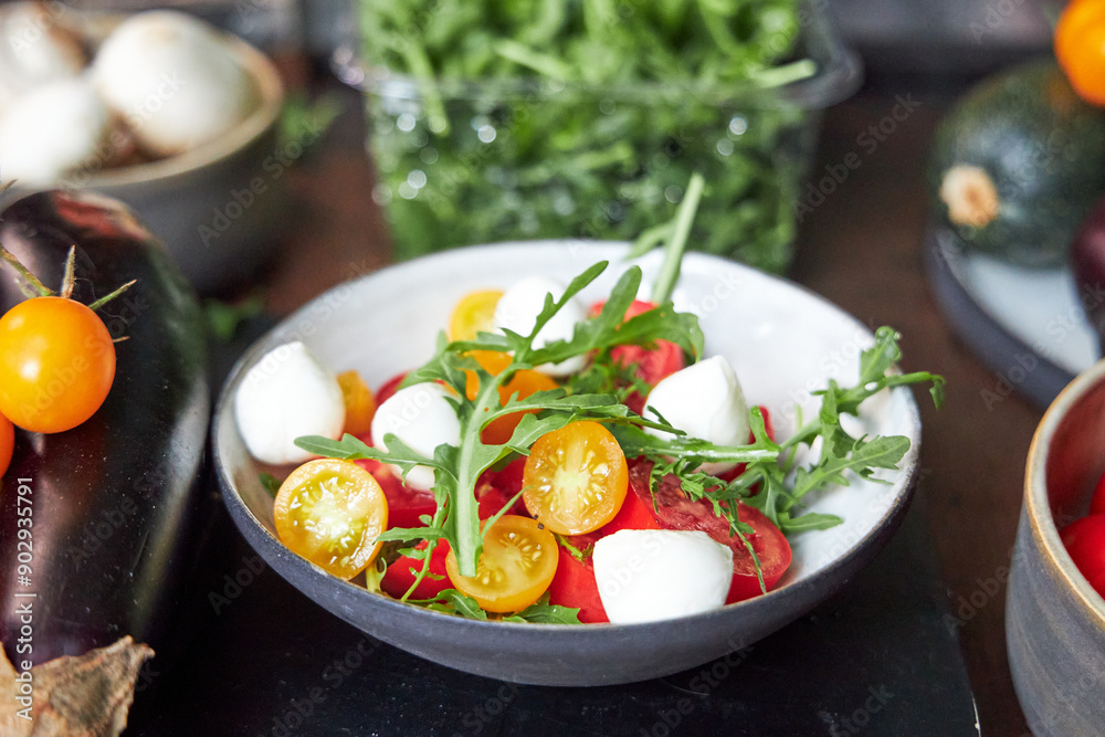 top view of ceramic bowl with tomato and cheese salad with herbs top view of ceramic bowl with tomato and cheese salad with herbs