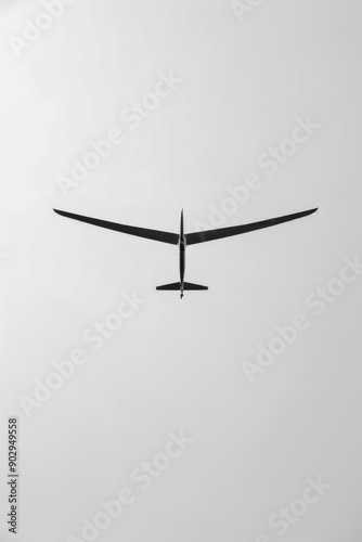 Soaring glider against clear sky, serene aerodynamics, black and white, high contrast, minimalist photography concept photo