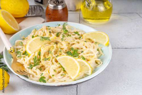 Homemade lemon pepper pasta, al limone spaghetti with creamy sauce with with lemon and pepper, copy space