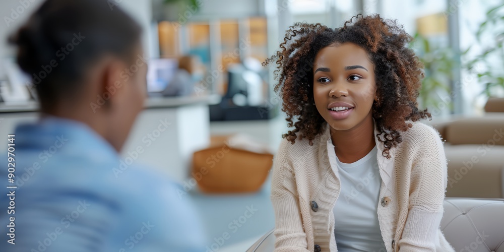 A woman with curly hair is talking to a man. The woman is smiling and the man is looking at her. Scene is friendly and positive A woman with curly hair is talking to a man. The woman is smiling and the man is looking at her. Scene is friendly and positive