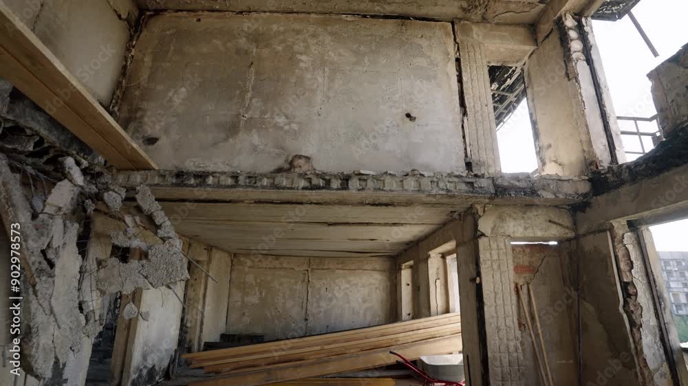 Interior of war-damaged apartment in Mariupol shows collapsed ceilings, exposed beams. Abandoned ruins reflect conflict impact in residential area, revealing destruction, loss. Interior of war-damaged apartment in Mariupol shows collapsed ceilings, exposed beams. Abandoned ruins reflect conflict impact in residential area, revealing destruction, loss.