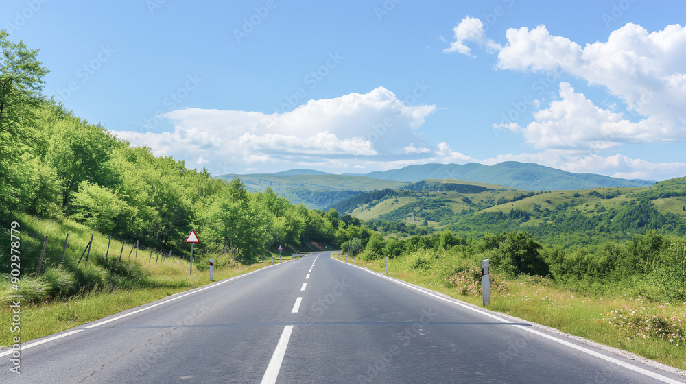 Naklejka premium Picturesque view of mountain road along mountain ridges and trees. Background with beautiful road and mountain view