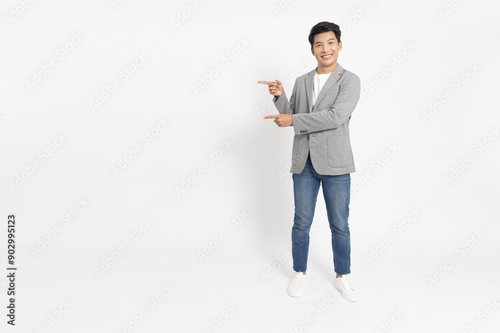 Young Asian businessman standing and pointing to empty copy space isolated on white background, Full body composition Young Asian businessman standing and pointing to empty copy space isolated on white background, Full body composition