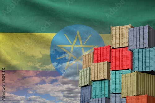 Ethiopia flag and big stack of shipping cargo containers in docks with sky background close up photo