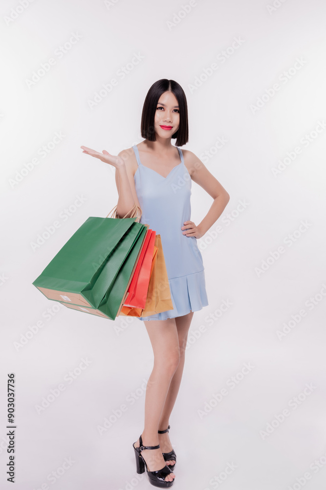 Shopping concept, Asian woman holding paper bag with confidence on white background. Shopping concept, Asian woman holding paper bag with confidence on white background.