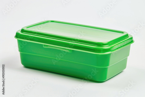 A green plastic lunch box isolated on a white background. photo