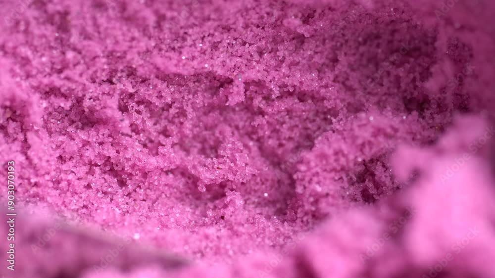 Metal spatula touching the pink kinetic sand. Textured, crumbly kinetic sand. Kinetic sand background. Metal spatula touching the pink kinetic sand. Textured, crumbly kinetic sand. Kinetic sand background.
