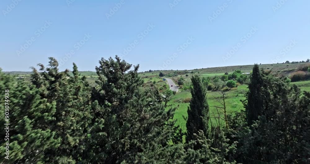 Aerial view of a road in the mountains of Cyprus. Countryside travel by car on the island of tourism. High quality 4k footage Aerial view of a road in the mountains of Cyprus. Countryside travel by car on the island of tourism. High quality 4k footage