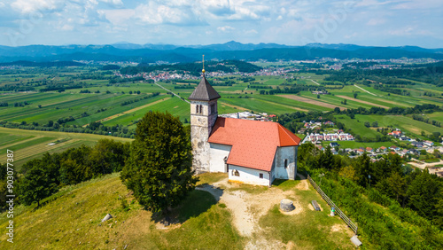 A stunning aerial view of Cerkev sv. Ane, Jezero, and Jezero pri Podpeči in Slovenia, captured by a drone. This captivating image showcases the picturesque church of St. Anne, serene lakes photo