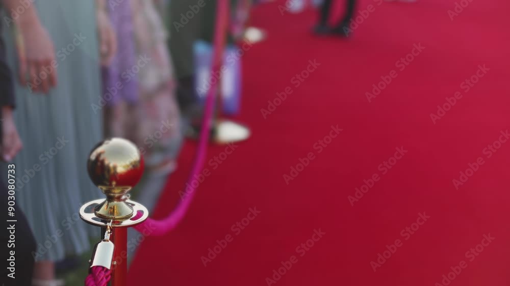 Red carpet with ropes and golden barriers on a luxury party entrance, cinema premiere film festival event award gala ceremony, wealthy rich guests arriving, outdoor decoration elements, summer day