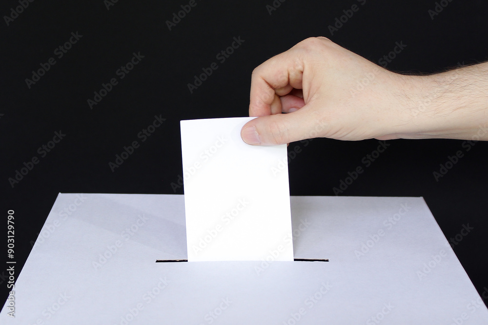 Closeup of caucasian male hand voting on black background Closeup of caucasian male hand voting on black background
