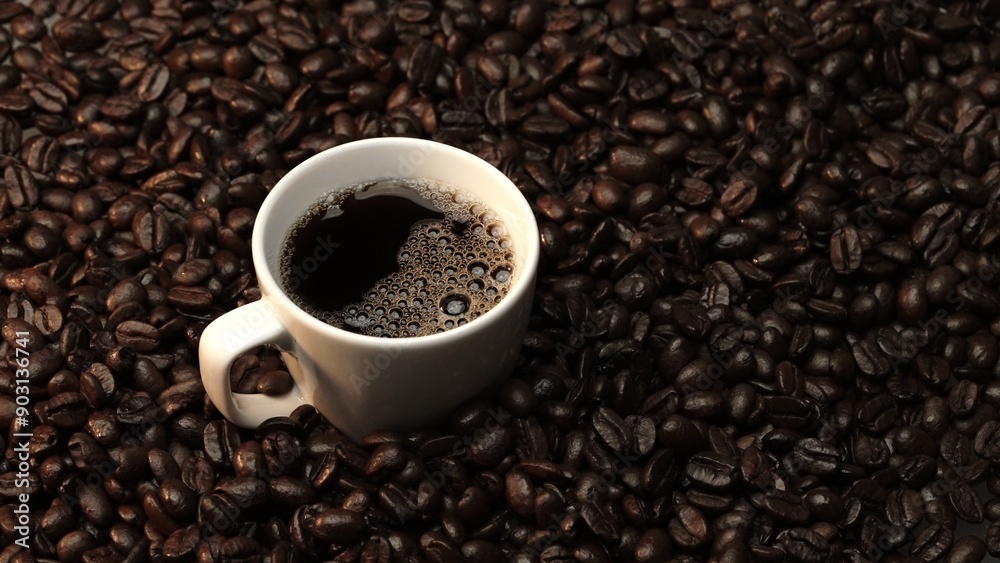Top view of coffee or espresso with piles of coffee beans. Close up of fresh roasted coffee bean scatter around wooden table with cup of americano and aromatic stream and smoke from seed. Comestible. Top view of coffee or espresso with piles of coffee beans. Close up of fresh roasted coffee bean scatter around wooden table with cup of americano and aromatic stream and smoke from seed. Comestible.