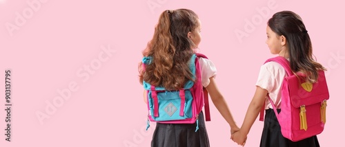 Little schoolgirls with bac...