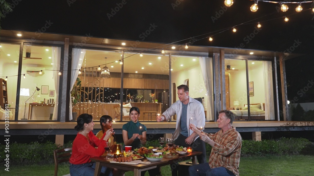 Happy family holding glowed sparkler in holiday celebration party at night. Lovely member enjoy playing spark toy together. Outdoor activity to cross generation gap strengthen family bond. Divergence. Happy family holding glowed sparkler in holiday celebration party at night. Lovely member enjoy playing spark toy together. Outdoor activity to cross generation gap strengthen family bond. Divergence.