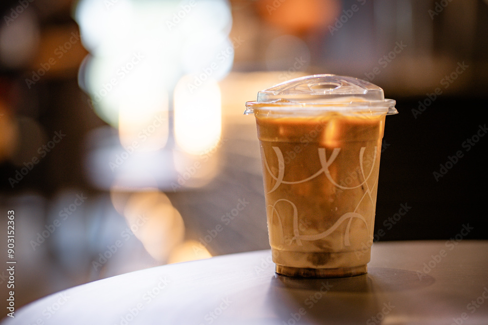 Close up and selective focus glass of ice latte on black table at coffee shop. Close up and selective focus glass of ice latte on black table at coffee shop.