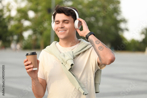 Handsome young man with cup...