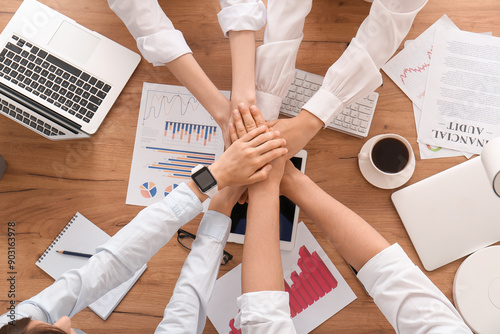 Business team putting hands...