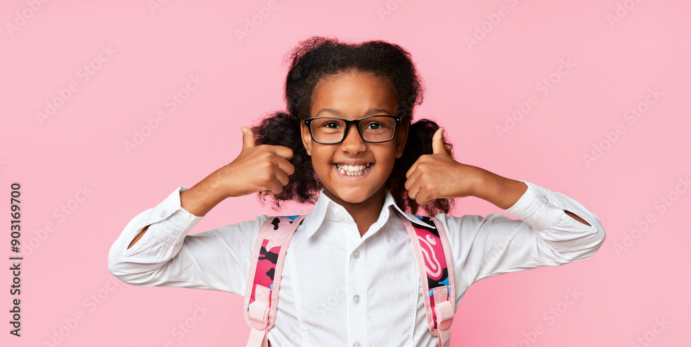 I Like School. Joyful African Schoolgirl Gesturing Thumbs Up Standing Over Yellow Studio Background. Panorama I Like School. Joyful African Schoolgirl Gesturing Thumbs Up Standing Over Yellow Studio Background. Panorama