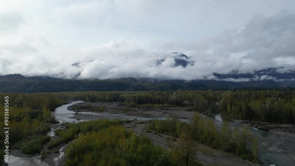 Winding River, Trees and Mountain Landscape, Cloudy Evening. Sunset, Summer season. Fraser Valley, British Columbia, Canada. Winding River, Trees and Mountain Landscape, Cloudy Evening. Sunset, Summer season. Fraser Valley, British Columbia, Canada.